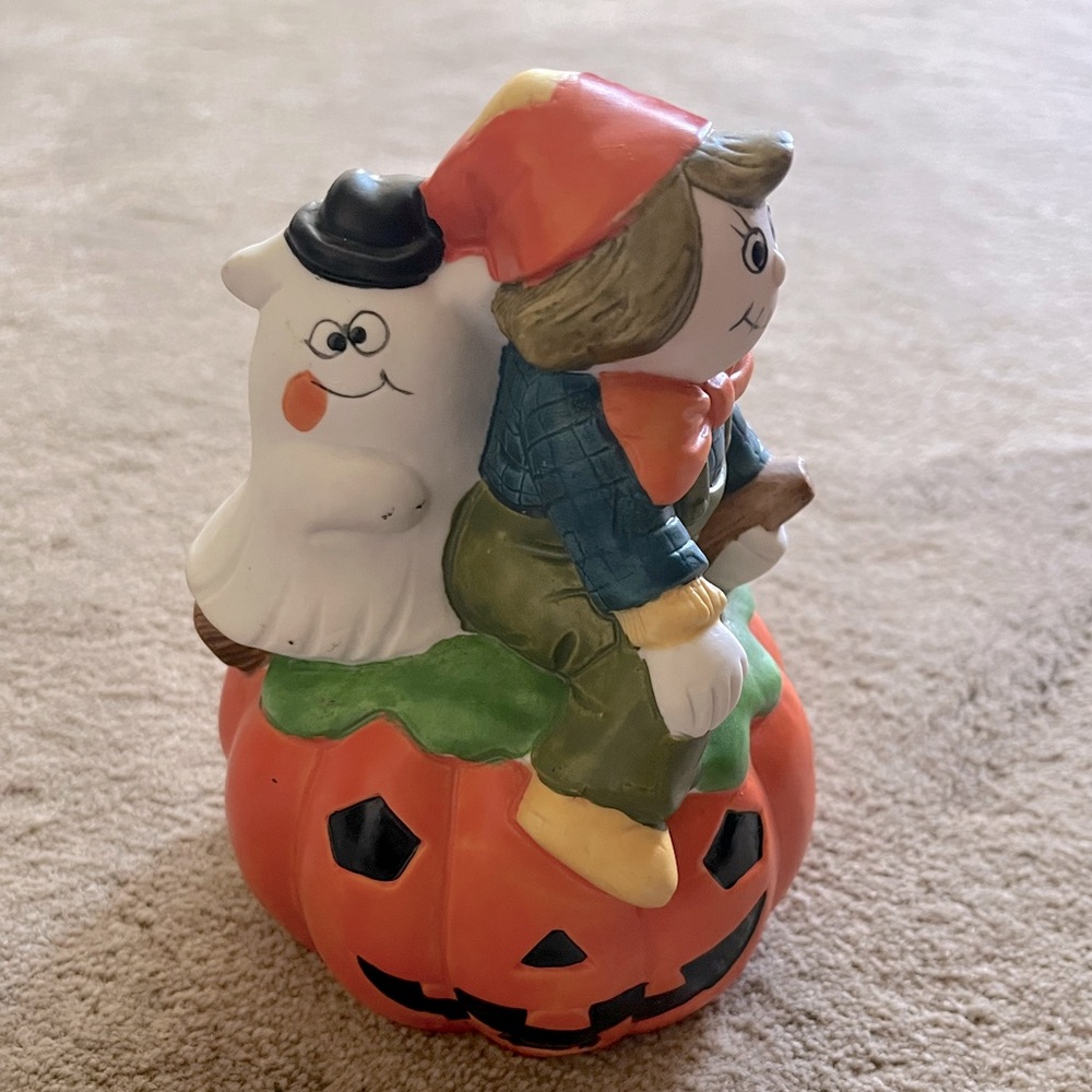 Halloween Fall decoration, scarecrow and ghost sitting on pumpkin